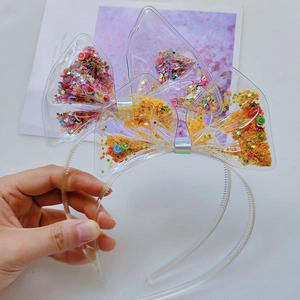 Detailed shot of transparent Christmas bow headband with colorful sequins and fruit slices