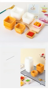 Macro detail of food-grade PET square mooncake trays in white and gold finishes