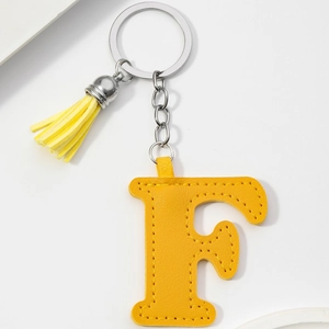 Detail of yellow PU leather letter F keychain with matching tassel and metal ring