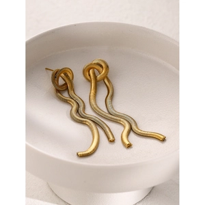 Detail of 16k gold plated stainless steel wavy spiral fringe earrings on white ceramic