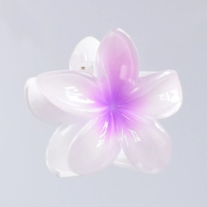 Detailed macro view of a 7cm purple gradient plumeria flower hair claw clip with glossy resin