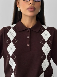 Detailed close-up of brown waffle knit polo sweater with white argyle pattern texture