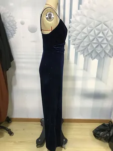 Detail of navy blue velvet jumpsuit showing slim-fit design and sparkling sequin texture