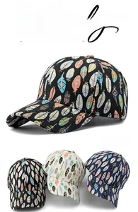 Detail of trendy baseball caps featuring colorful feather prints in three assorted colors