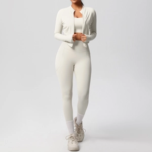 Three-piece yoga set featuring a zip-up jacket, sports bra, and high-waist leggings in cream