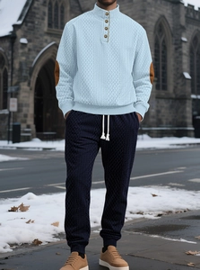 Close-up of light blue stand collar jacquard sweater set with contrast elbow patches