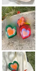 Detail of sweet heart-shaped acetate hair claws in colorful layered resin design
