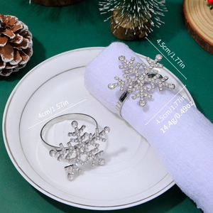 Detail view of silver snowflake napkin rings showing 4cm and 4.5cm sizes with weights