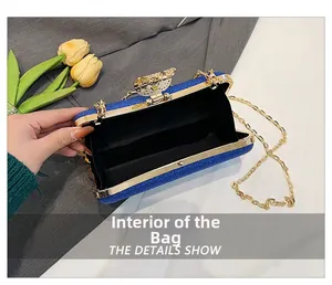 Blue glitter evening clutch with gold metal frame, chain strap and black fabric lining