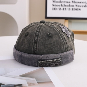 Close-up of vintage charcoal denim docker hat with side star patch and fabric label details