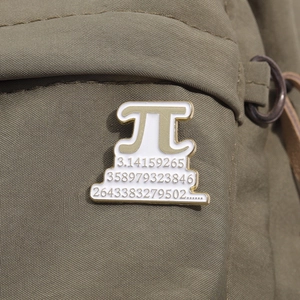 Mathematical Pi symbol enamel pin with white sequence on green canvas texture