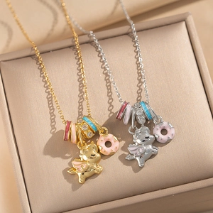 Gold and silver enamel unicorn and donut necklaces displayed in a premium jewelry box