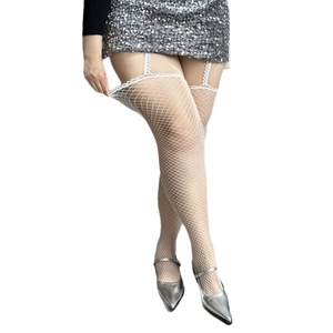 White fishnet tights with lace top and garter details worn with silver skirt and shoes