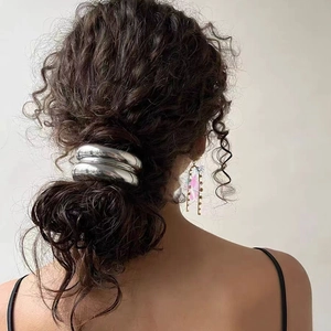 Minimalist silver metal chain semi-circle hair tie shown on model ponytail hairstyle