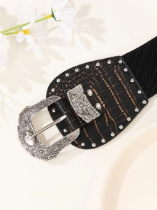 Detail of vintage black elastic waist belt with engraved silver buckle and rivet studs