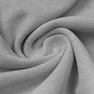 Macro shot of grey waffle knit fabric texture showing breathable honeycomb weave detail