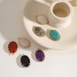 Macro shot of oval natural stone pendants with gold-plated edges in various colors