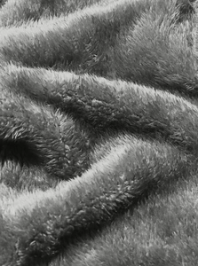 Macro shot of soft gray polar fleece fabric texture showing plush warmth and fibers