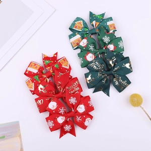 Detailed macro of Christmas ribbon bow clips featuring Santa, reindeer and snowflake prints