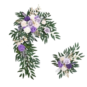 Detail view of purple and cream artificial rose garland set with realistic green foliage