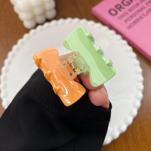 Pastel candy color small hair claws in green and orange with gold metal springs