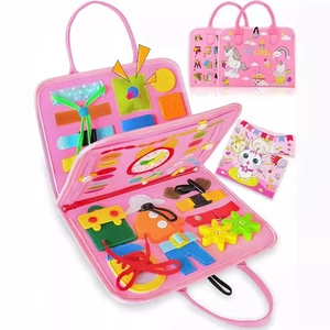 Pink unicorn felt busy board featuring zippers, buttons, and clock for toddler fine motor skills