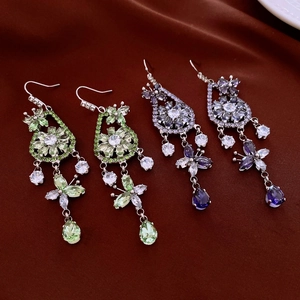 Detailed view of luxury zircon drop earrings with butterfly and flower patterns