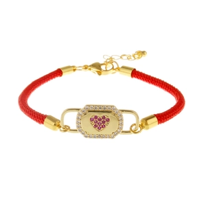 Red braided rope bracelet featuring a golden charm with a pink zircon heart and small diamonds