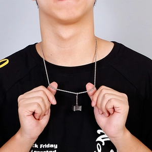 Detailed close-up of men's stainless steel Thor's hammer pendant on a twisted rope chain