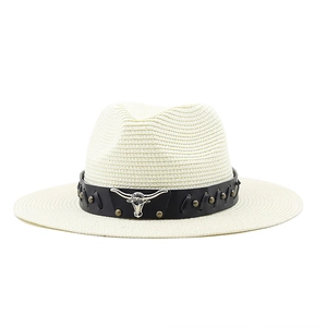Detail of western straw hat featuring a metal longhorn skull and black leather band