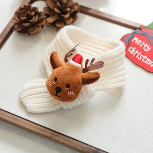 Detailed view of white knitted pet Christmas scarf with cute plush reindeer ornament