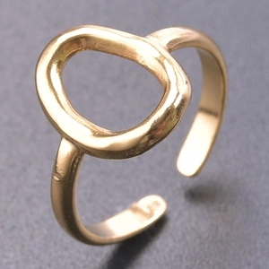 Detail of golden adjustable open ring featuring a large irregular oval geometric hoop