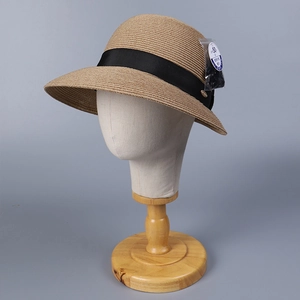 Seitenansicht eines eleganten Strohhutes mit schwarzer Schleife und UPF 50+ Etikett