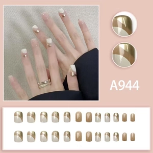 Short square press-on nails with cream gold geometric patterns and nude champagne design