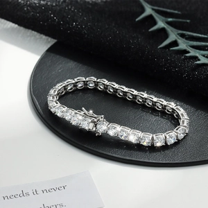 Macro detail of silver tennis bracelet with cubic zirconia stones and secure safety clasp