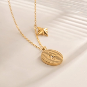 Gold stainless steel necklace with oval north star pendant and cubic zirconia