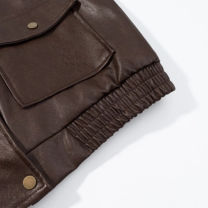 Brown vintage PU leather jacket featuring functional pockets and an elasticated hem detail