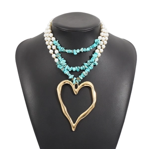 Bohemian multilayer necklace with large gold heart pendant and turquoise pearl beads