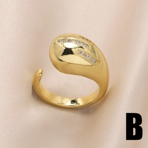 Irregular golden heart ring with rows of white zircon on champagne silk background