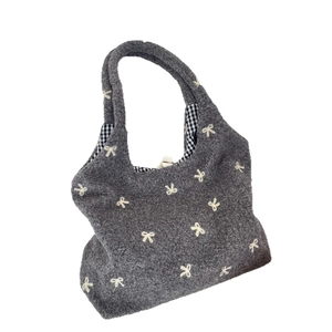 Grey plush tote bag with embroidered bows and monochrome gingham lining interior