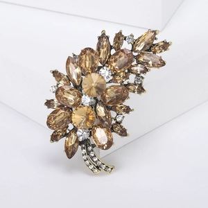Detailed close-up of champagne crystal tree brooch with vintage gold alloy leaves