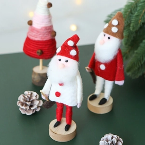 Handmade wool felt Santa Claus and pink Christmas tree figurines with wooden bases