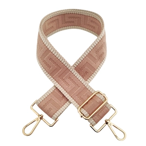 Close-up of pink and white geometric jacquard bag strap with gold alloy lobster hooks