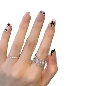 Classic French press-on nails with black stars and monochrome stripes on short coffin shape