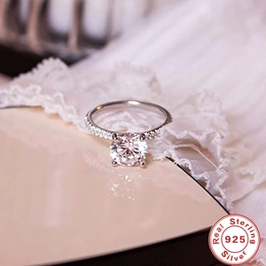 Close-up of a 925 sterling silver diamond ring with micro-pave band and luxury details