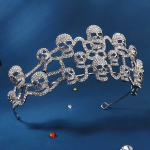 Close-up of gothic silver tiara featuring rhinestone skulls and intricate metalwork