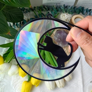 Detailed macro view of black cat crescent moon suncatcher with iridescent rainbow film