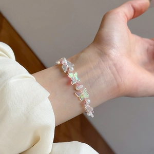 Elegant acrylic butterfly beaded bracelet with faux crystal pearls and pink accents