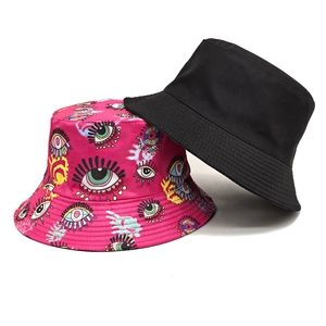 Reversible bucket hat set with minimalist black and vibrant colorful eye pattern prints