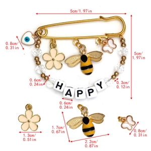 Size diagram for gold Evil Eye brooch pin with bee, butterfly charms and HAPPY letters